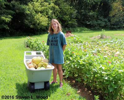 Granddaughter Katherine, melons, and zinnias