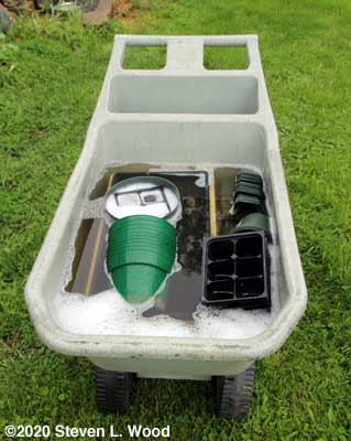 Soaking pots, inserts, and trays in bleach water