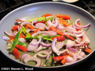 Cooking peppers, garlic, and onions from our garden