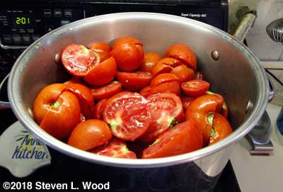 Tomatoes washed and cut and beginning to heat up